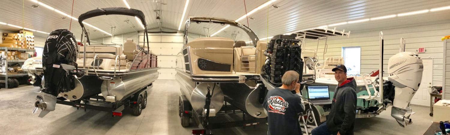 2 men working on 2017 G22 Swingback Pontoon Boats